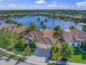Aerial view of a lakeside property with lush landscaping and proximity to a serene lake at 518 Luminary Blvd, Osprey, FL 34229