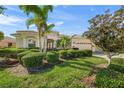 Charming single-story home featuring lush landscaping, a well-manicured lawn and a two-car garage at 518 Luminary Blvd, Osprey, FL 34229