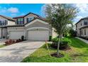 Two-car garage, paver driveway, and landscaping at 6055 Worsham Ln # 104, Lakewood Ranch, FL 34211