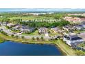 Aerial view of a home on a large .31 acre private lot, surrounded by lush greenery and a lake at 6318 Anise Dr, Sarasota, FL 34238