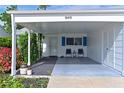 Covered carport with seating area and lush landscaping at 9411 Andover Cir, Bradenton, FL 34210