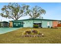 Charming home exterior with a well-maintained lawn and colorful landscaping, enhancing curb appeal at 1000 Dartmouth Dr, Bradenton, FL 34207