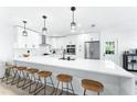 Modern kitchen with white cabinets, quartz countertops, and a large island at 1756 Livingstone St, Sarasota, FL 34231