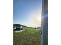 Landscape view of a grassy land, near vehicles and mobile homes in the distance at 2815 Us-41 N, Palmetto, FL 34221