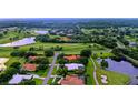 Aerial view showcasing a house nestled in a golf course community near lakes at 3105 Charles Macdonald Dr, Sarasota, FL 34240