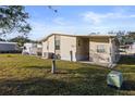 Side view of a manufactured home showcasing a large yard at 3386 Oakwood N Blvd, Sarasota, FL 34237