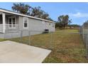 Side view of gray house with chain link fence at 420 21St E St, Palmetto, FL 34221