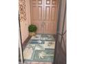 Front entry with double doors and a tropical-themed floor mat at 4311 65Th E Ter, Sarasota, FL 34243