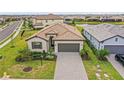 An aerial view of a single-Gathering home showcasing a beautiful tile roof and long driveway at 5107 Coral Reef Way, Bradenton, FL 34211