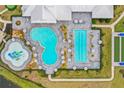 An aerial view of a community pool, featuring a splash pad, lap pool, and ample seating at 5107 Coral Reef Way, Bradenton, FL 34211