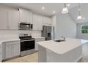 Kitchen featuring shaker style cabinets, stainless steel appliances, and quartz countertops at 5658 Silverbridge Trl, Bradenton, FL 34211