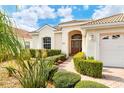 Home's exterior entrance with well-manicured landscaping and walkway at 6504 Copper Ridge Trl, Bradenton, FL 34201