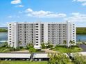 Condo building exterior showcasing parking and waterfront location at 9397 Midnight Pass Rd # 906, Sarasota, FL 34242