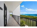 Hallway with ocean view, leading to condo unit at 9397 Midnight Pass Rd # 906, Sarasota, FL 34242