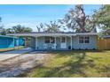 Inviting single-story home with a covered carport, a front porch, and well-maintained landscaping at 1524 2Nd E Ave, Bradenton, FL 34208