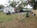 Backyard view, showing a green yard and various debris at 1814 6Th E Ave, Bradenton, FL 34208