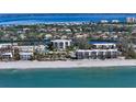 Aerial view of condo building near beach and waterway at 3240 Gulf Of Mexico Dr # B504, Longboat Key, FL 34228