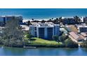 Aerial photo showing condo building near beach and waterway at 3240 Gulf Of Mexico Dr # B504, Longboat Key, FL 34228