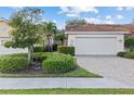 Well-maintained villa with a white garage door and brick paver driveway at 3841 Albacete Cir # 51, Punta Gorda, FL 33950