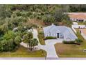 Charming single-story home with manicured landscaping and a paved driveway at 4801 Brickell Dr, North Port, FL 34286
