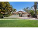 Beautiful Mediterranean-style home with lush landscaping, a green lawn and a two-car garage at 4946 Brywill Cir, Sarasota, FL 34234
