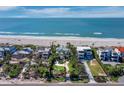 Stunning aerial view of beachfront homes, showcasing their proximity to the ocean and beautiful landscaping at 6161 Gulf Of Mexico Dr, Longboat Key, FL 34228