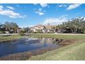 Luxury home showcasing a tranquil pond and lush landscaping at 6200 Saddle Oak Trl, Sarasota, FL 34241