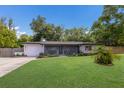 Inviting single-story house with a manicured lawn, screened porch, and a well-kept garden enhancing its curb appeal at 671 47Th St, Sarasota, FL 34234