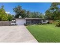 Charming home with a spacious driveway and a well-manicured lawn adding to its curb appeal at 671 47Th St, Sarasota, FL 34234