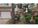 Exterior view of townhouse with landscaping, walkway, and garage at 7307 Fountain Palm Cir # 7-102, Bradenton, FL 34203
