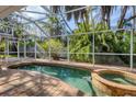 Relaxing kidney-shaped pool with spa and screened enclosure at 118 24Th W St, Bradenton, FL 34205