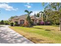 House exterior showcasing a driveway and lush landscaping at 22435 Panther Loop, Bradenton, FL 34202