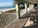 This balcony view features outdoor seating and stunning views of the beach and Gulf of Mexico at 2310 Gulf N Dr # 205, Bradenton Beach, FL 34217