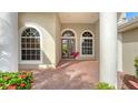 Elegant entryway with arched windows and double doors leading into the home at 2886 Grazeland Dr, Sarasota, FL 34240