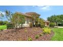 Well-maintained side yard with lush landscaping and beautiful flowering trees at 2886 Grazeland Dr, Sarasota, FL 34240