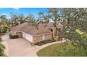 House with a three-car garage and a nicely landscaped yard at 2957 Wilderness E Blvd, Parrish, FL 34219