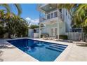 Relaxing rectangular pool with surrounding patio and lounge chairs at 307 Spring Ave, Anna Maria, FL 34216