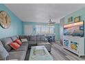 Bright living room with sectional sofa, TV, and dining area at 4460 Ironwood Cir # 403A, Bradenton, FL 34209