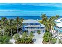 Beautiful waterfront residence with multiple balconies and well-maintained driveway and landscaping at 506 S Casey Key Rd, Nokomis, FL 34275
