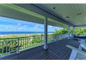 Relaxing ocean view deck with seating and a large covered area at 506 S Casey Key Rd, Nokomis, FL 34275