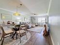 Bright living room features stylish furniture, hardwood floors, and a dining area at 707 Sorrento Inlt # 707, Nokomis, FL 34275