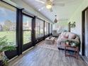 Relaxing sunroom with comfy seating, wood-look floors, and access to the backyard at 707 Sorrento Inlt # 707, Nokomis, FL 34275