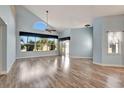 Spacious living room featuring hardwood floors and large windows at 741 Fairway Ridge Ct, Sun City Center, FL 33573