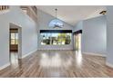 High-ceilinged living room with hardwood floors and view to backyard at 741 Fairway Ridge Ct, Sun City Center, FL 33573