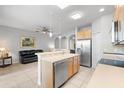 Open kitchen features a breakfast bar and stainless steel appliances at 8003 Limestone Ln # 15-103, Sarasota, FL 34233