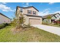 Two-story house with a two-car garage and landscaped yard at 9011 Waxwing Way, Parrish, FL 34219