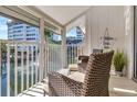 Relaxing screened balcony with wicker chairs and pond views at 1130 W Peppertree Ln # 118, Sarasota, FL 34242