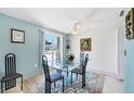 Dining area with a glass table and a floral rug at 2271 Sandlewood Dr, Venice, FL 34293