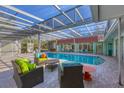 Enclosed pool area with comfortable seating, tiled deck, and serene outdoor living space at 2605 Desoto Rd, Sarasota, FL 34234