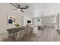 Bright living room and dining area with tiled flooring and natural light at 5164 Windward Ave, Sarasota, FL 34242